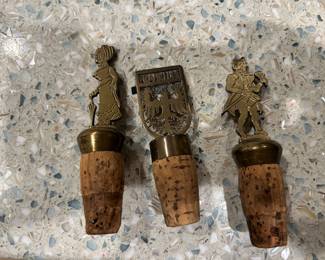 Three vintage brass wine stoppers-$90