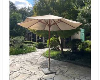 Frontgate wooden umbrella with stone base. features a traditional rope-and-pulley system and is secured by a pin. Overall measurements is 100H × 20W.-$800