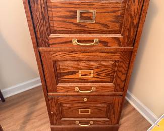 Vintage Oak Filing Cabinet – Traditional wooden three-drawer filing cabinet with brass-tone drawer pulls.
