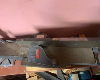 Shopsmith woodworking jointer attachment resting on a workbench, showing slight surface wear.