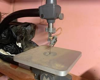 Vintage Shopsmith scroll saw attachment mounted on a wooden base with attached dust collection hose.