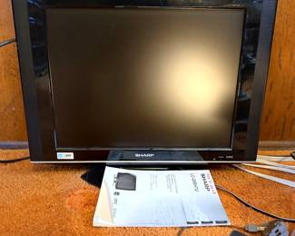 Sharp AQUOS LC-20SH7U liquid crystal television in black, complete with original user manual dated 2008 and remote control.