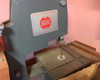 Shopsmith bandsaw attachment in grey plastic casing, showing normal dust and wear from use.
