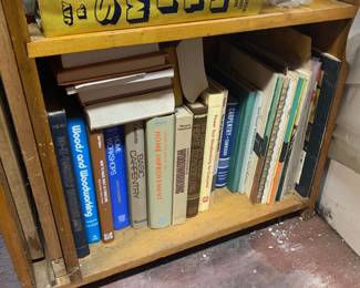 Wooden shelf filled with vintage DIY, woodworking, carpentry, and home improvement instruction books.