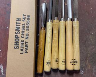 Shopsmith lathe chisel set (part no. 505586) featuring six woodturning tools with light and dark wooden handles, alongside their original cardboard box.