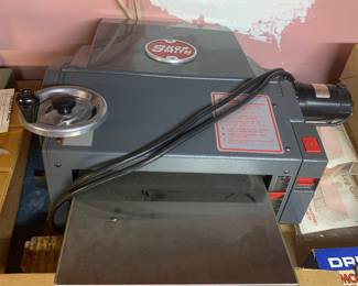 Shopsmith benchtop thickness planer tool sitting above a boxed Shopsmith lathe chisel set.