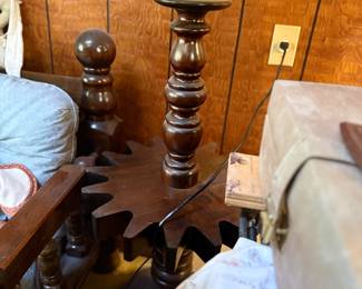 Vintage dark stained wood floor lamp table with turned spindle central post and gear-shaped accent tray.