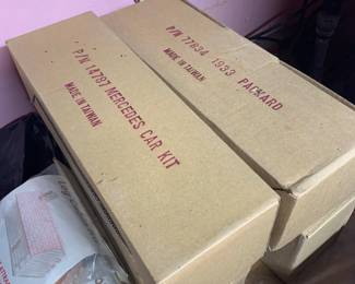 Vintage model car kits in original cardboard packaging, including a Mercedes car kit and a 1933 Packard kit, both made in Taiwan.