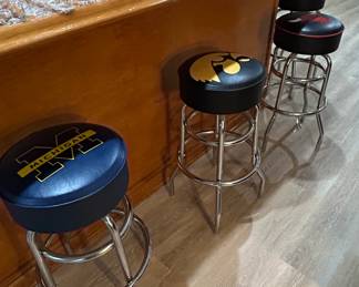 Collection of Four Collegiate and Professional Sports Logo Bar Stools