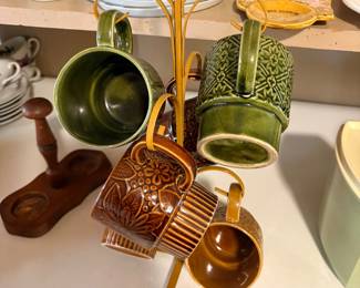 vintage 1970s ceramic mug tree set with embossed patterned coffee mugs and a matching metal display stand