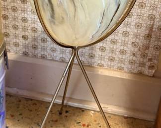 vintage mid-century modern atomic-style bullet planter with a swirled or marbled cream/beige fiberglass bowl resting in a brass-toned metal tripod stand