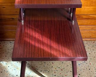 vintage mid-century modern two-tier step end table with a reddish wood-grain or laminate finish, brass accents, and angled tapered legs set of 2