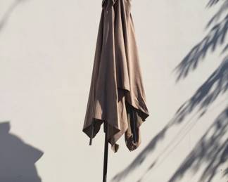 Lot 436 Tan colored outdoor patio umbrella with cast