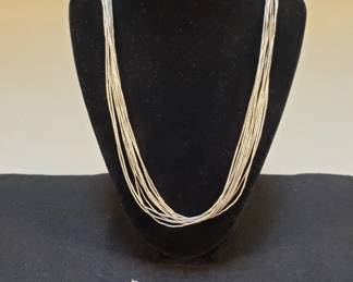 Lot 310 Vintage liquid silver necklace, sterling and wood pendant, and sterling bracelet. necklace