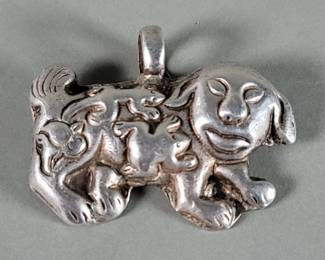 Lot 529 Vintage silver animal pendant featuring a traditional Chinese guardian dog. unmarked, scratch
