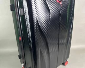 Lot 435 Puma hardside spinner suitcase with a carbonfiber style pattern exterior