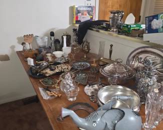 Estate Sale – Vintage Collectibles & Home Décor Assorted vintage collectibles, figurines, decorative glassware, pottery, silver-tone serving pieces, and unique home accessories. Keywords: Vintage, Antiques, Collectibles, Figurines, Glassware, Silver, Silverplate, Pottery, Home Décor, Decorative Accessories, Estate Sale.