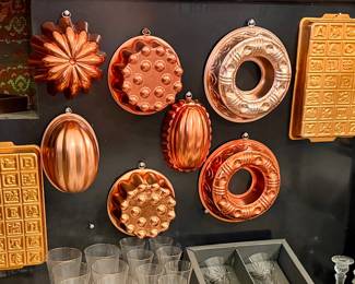 Beautiful collection of vintage copper and copper-colored baking molds, featuring decorative shapes and classic designs