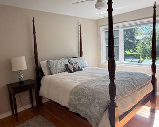 Queen-size impressive high-post Colonial Revival Rice bedframe carved from rich mahogany. From Marshall Fields. Includes canopy rails.