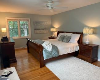 King-size cherrywood sleigh bed; two bedside tables,; low dresser.