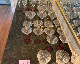 Vintage colllecgtion of mid-century crystal stemware featuring hand-etched floral and ruby-red bases.