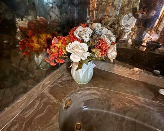 Marble-style garden tub with silk floral arrangements