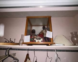 Closet shelf with framed mirror and hanging clothing