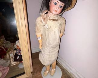 Collectible doll in straw bonnet and cream dress