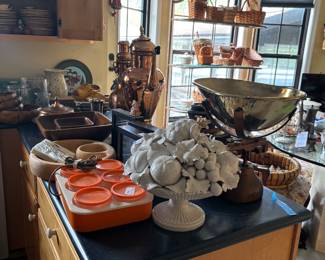 Kitchen island with bowls, pottery and copper decor
