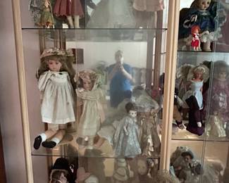 Display cabinet of collectible porcelain and bisque dolls
