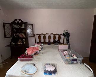 Bedroom with table of linens and secretary bookcase
