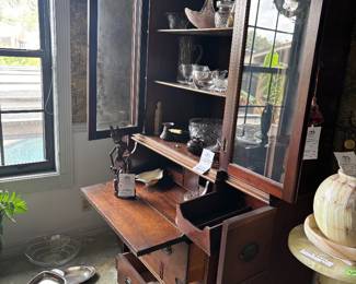 Wood secretary hutch with glass doors and dishes