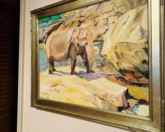 Framed painting of elephant at rocky shoreline