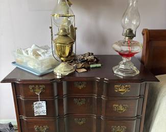 Mahogany-finish block front chest with oil lamps and brass lamp