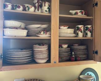 Kitchen cabinet of dishes, mugs and bowls