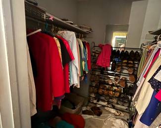 Walk-in closet with women's tops, jackets and shoe rack