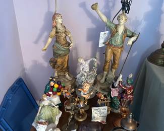 Figural lamps on side table with figurines and brass items