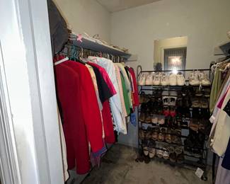 Walk-in closet with women's clothing and shoe rack