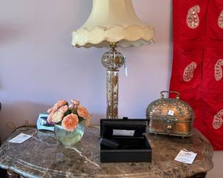 Marble-top nightstand with tassel-shade lamp and jewelry box