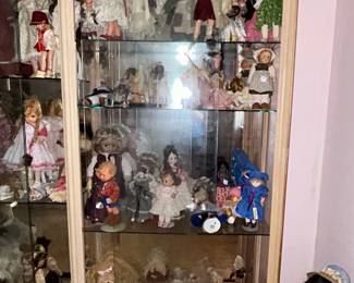 Lighted glass display cabinet of collectible dolls
