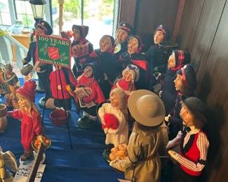 Table of collectible dolls in costumes with blue cover