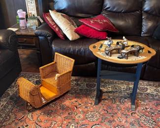 Den with leather sofa, wood rocking cradle and Persian-style rug