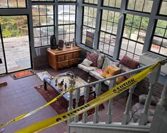 Sunroom overview with tables, settee and red tile floor