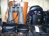 Many binoculars in cases.