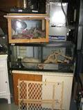 several tanks for fish or reptiles, complete with lights and supplies