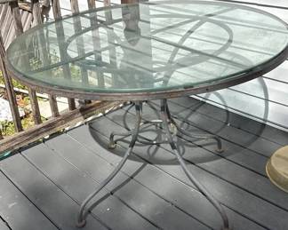 Oval GlassTop Patio Dining Table with Decorative Metal Scrollwork Base