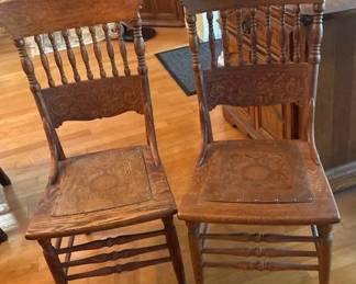 Pair of Antique Oak Spindle Back Dining Chairs with Embossed Leather Seats  Carved Details