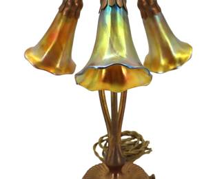 Lot 1522 Art Nouveau Style Tiffany Studios ThreeLight Bronze Finished Lily Table Lamp with Iridescent FavrileStyle Glass Shades