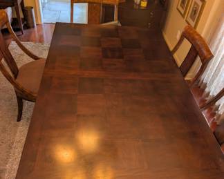 Dining room extension table, one leaf, checkerboard design, six chairs.