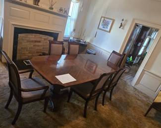 **Traditional Wooden Dining Room Set β Elegant Dining Table & Upholstered Chairs** Beautiful traditional dining room set featuring a generously sized wooden dining table with a rich polished finish and coordinating upholstered chairs\. The table showcases a classic design with elegant lines and a substantial pedestal\-style base\. The coordinating chairs feature decorative wooden frames and upholstered seats and backs, creating a sophisticated and timeless dining room aesthetic\. Perfect for family gatherings, holiday dinners, or anyone furnishing a traditional home\. **Condition:** Pre\-owned with normal signs of use\. Sold as a set.